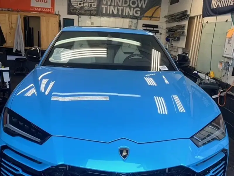 Blue Lamborghini Urus in the window tinting bay