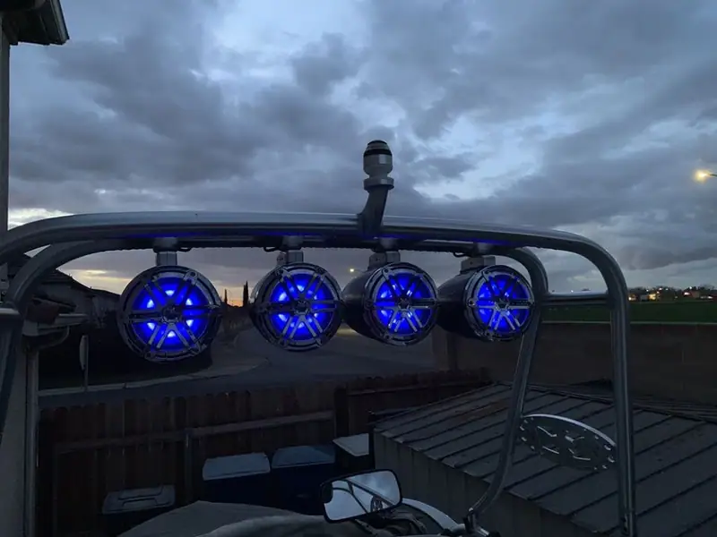 Boat tower speakers lit with blue lighting at dusk