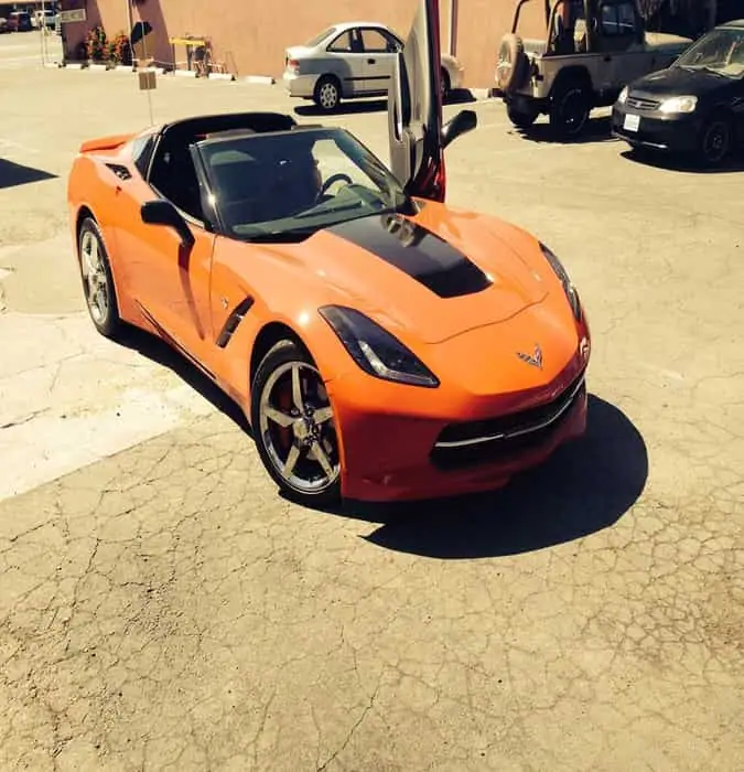 Orange Chevrolet Corvette Stingray with the top off