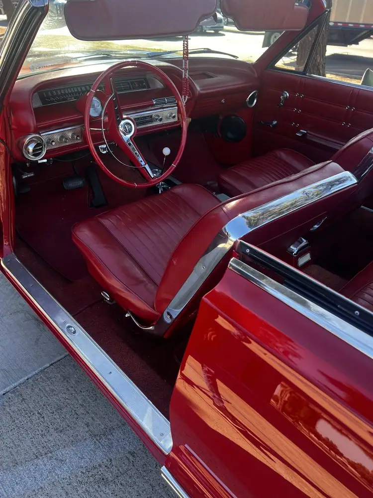 Classic car interior with red upholstery and a custom stereo installation