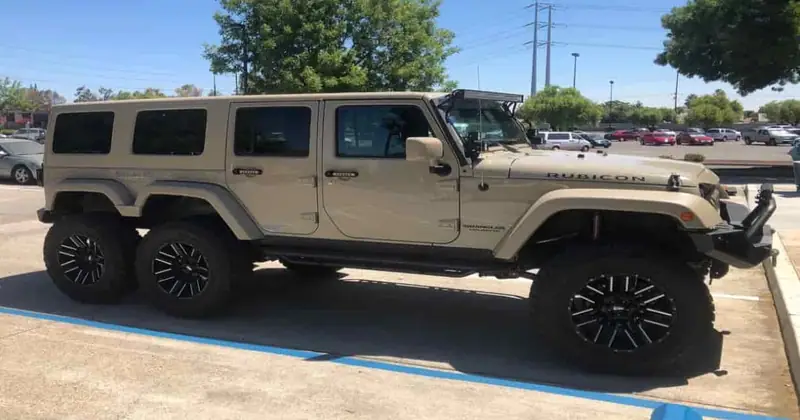Tan six-wheel custom Jeep Wrangler in a parking lot