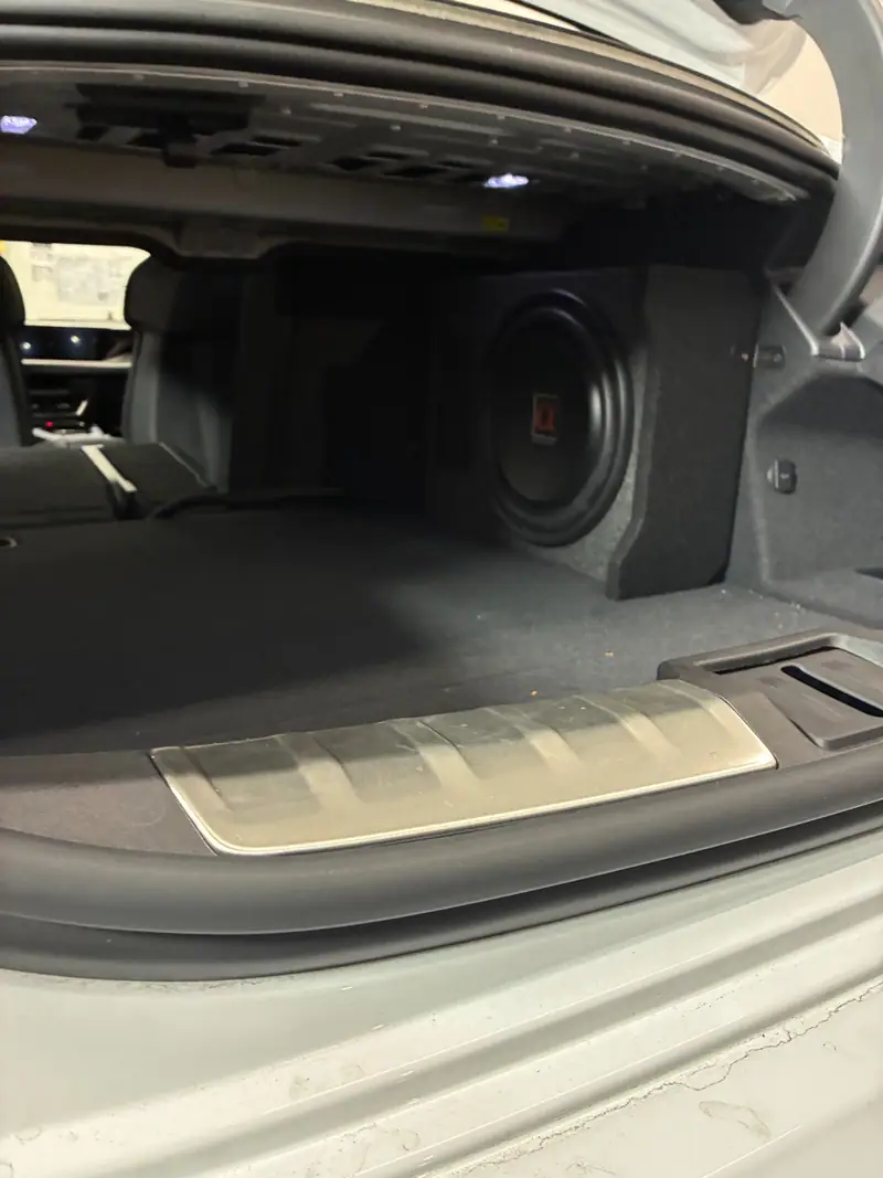 Custom-fitted subwoofer enclosure installed in the rear cargo area of a vehicle