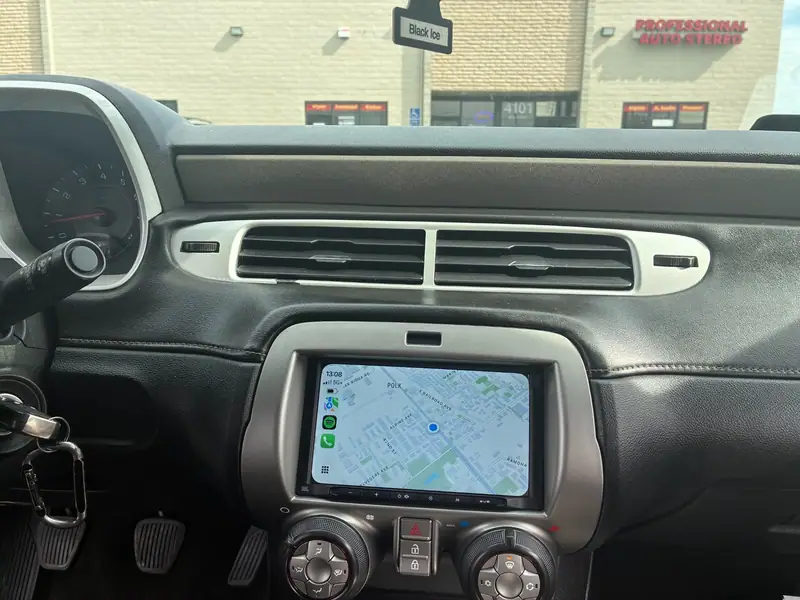 JBL touchscreen receiver showing Apple CarPlay maps in a car dashboard
