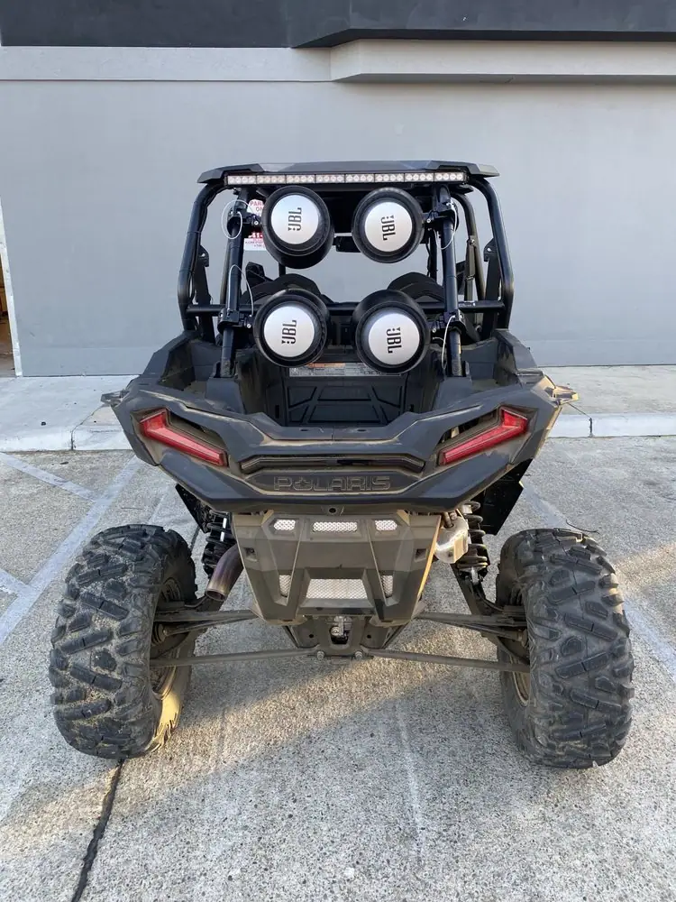 Rear view of a UTV with four speakers mounted on the cage