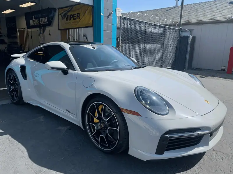 White Porsche 911 parked at the shop