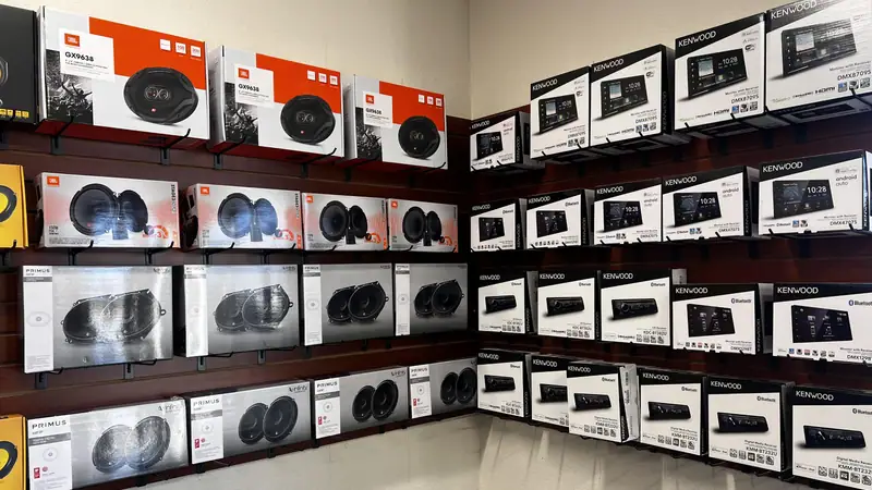 Wall of boxed car speakers on shelves