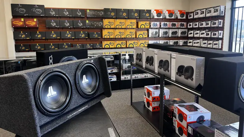 Subwoofers, enclosures and speakers on display at a Professional Auto Stereo store
