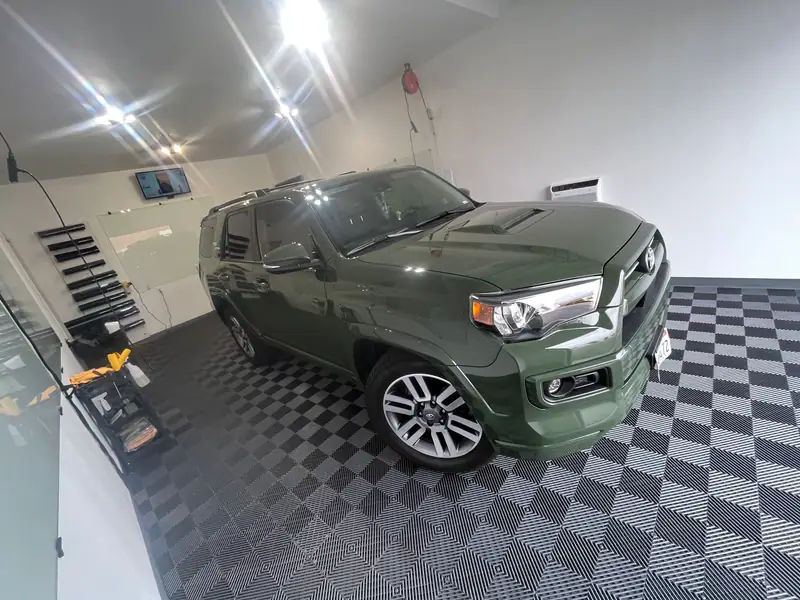 Green Toyota 4Runner parked in a clean window tint bay