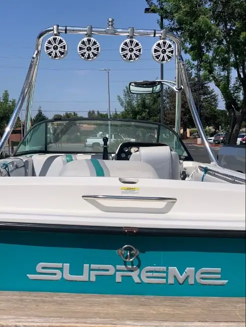 Boat with a speaker rack mounted on the tower